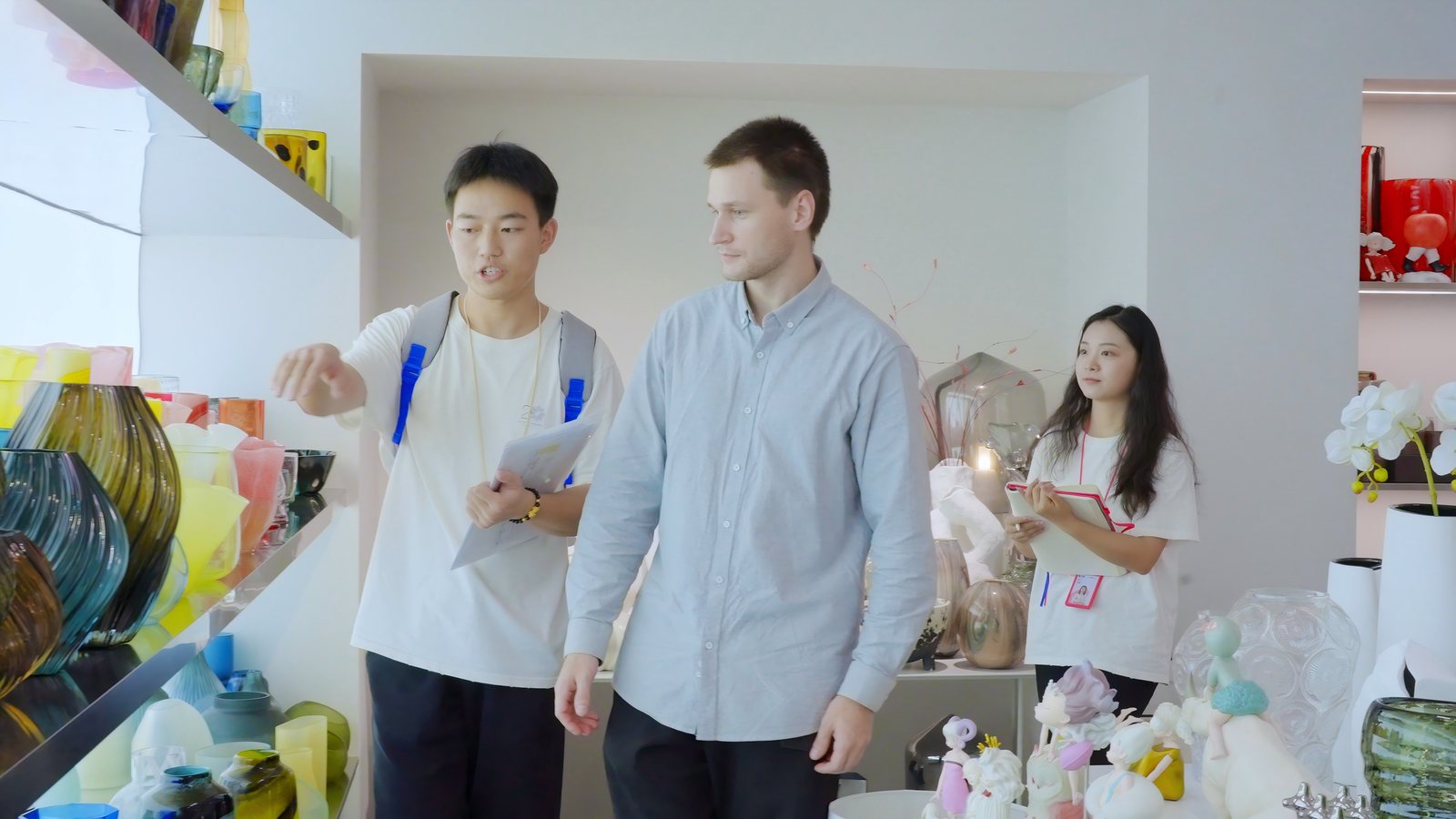 MU Group's sourcing team reviewing a glassware and ceramics range with a visiting buyer.